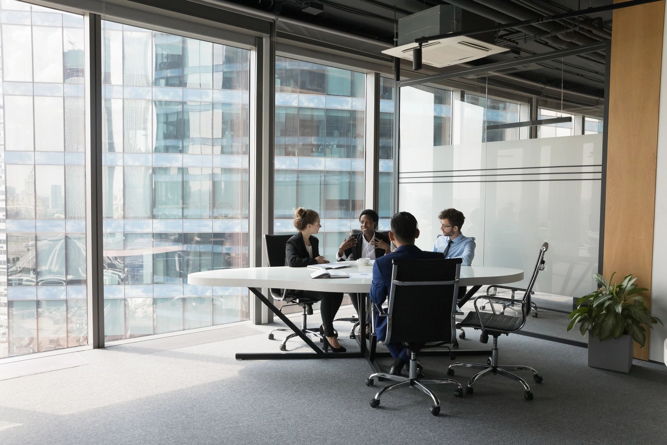 Technology consulting team collaborating in a modern meeting room