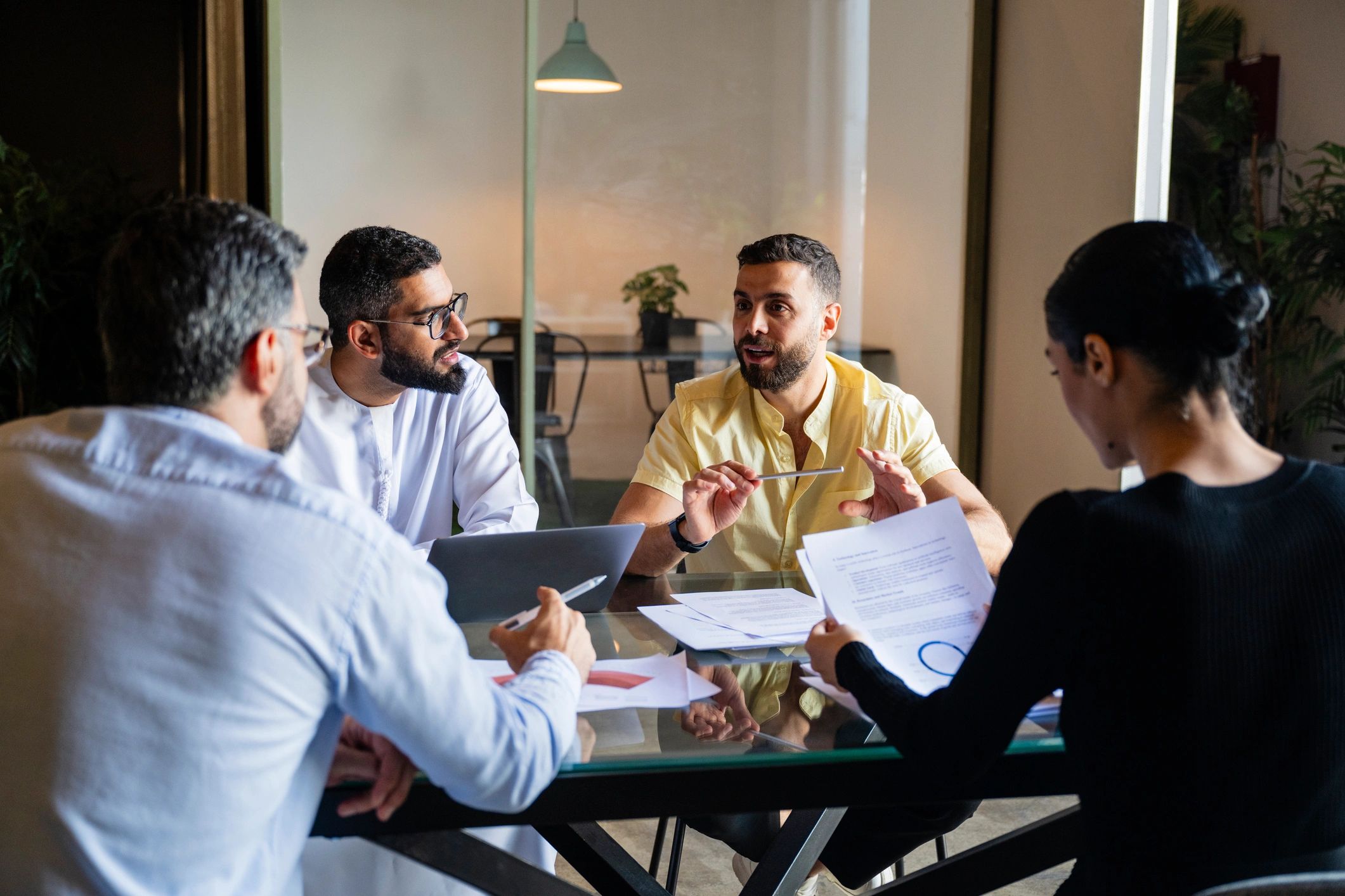 Business professionals reviewing plans in a meeting